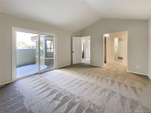 unfurnished bedroom with access to exterior, light colored carpet, and lofted ceiling