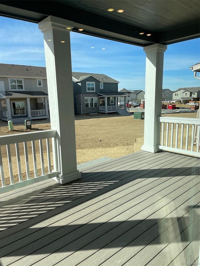 wooden terrace with a residential view and covered porch