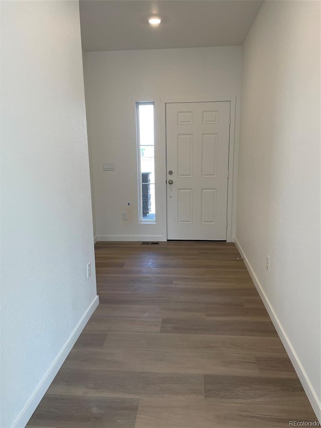 entryway with visible vents, wood finished floors, and baseboards