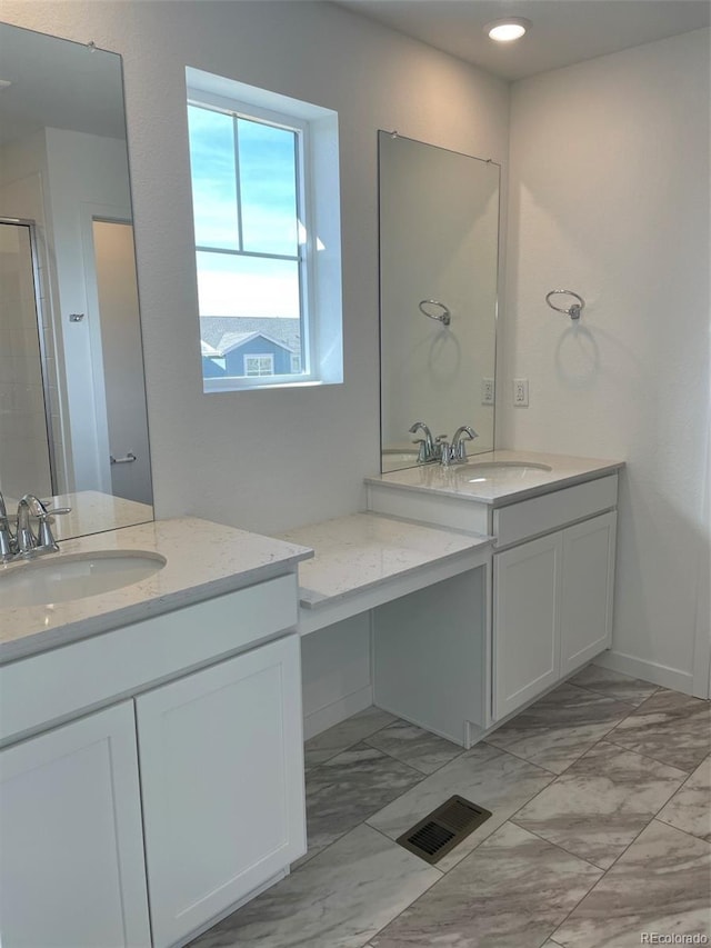 bathroom with visible vents, marble finish floor, two vanities, and a sink