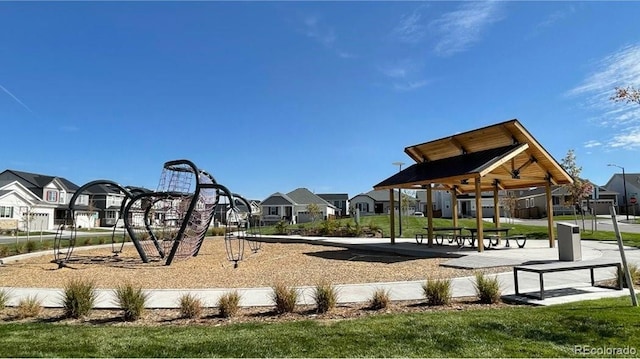 view of community featuring a residential view, playground community, and a yard