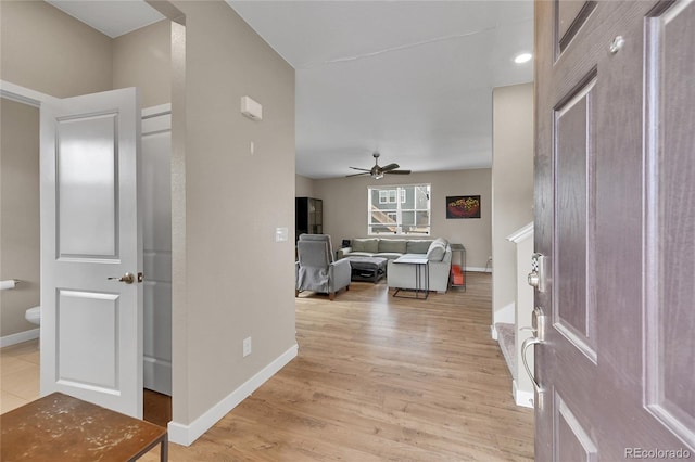 7465 E 157th Pl, Thornton, CO 80602 - foyer entrance with a ceiling fan, light wood finished floors, and baseboards