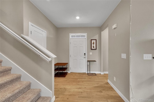 7465 E 157th Pl, Thornton, CO 80602 - foyer entrance with stairway, light wood-style flooring, and baseboards