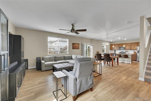 7465 E 157th Pl, Thornton, CO 80602 - living room featuring ceiling fan, light wood-type flooring, baseboards, recessed lighting, and stairs