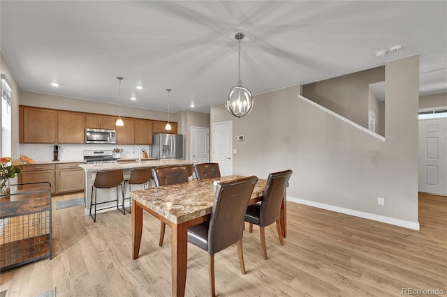 7465 E 157th Pl, Thornton, CO 80602 - dining area with baseboards, light wood-type flooring, recessed lighting, and a chandelier