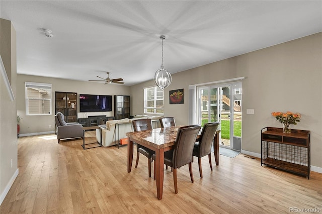 7465 E 157th Pl, Thornton, CO 80602 - dining area featuring light wood-type flooring, baseboards, ceiling fan, and a chandelier