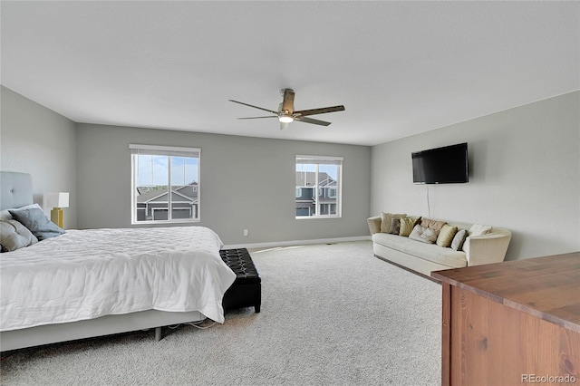 7465 E 157th Pl, Thornton, CO 80602 - carpeted bedroom featuring multiple windows, baseboards, and a ceiling fan