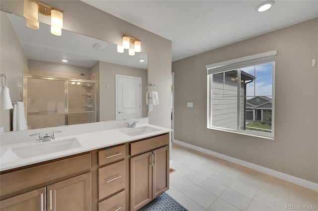 7465 E 157th Pl, Thornton, CO 80602 - bathroom featuring a shower stall, double vanity, baseboards, tile patterned floors, and recessed lighting