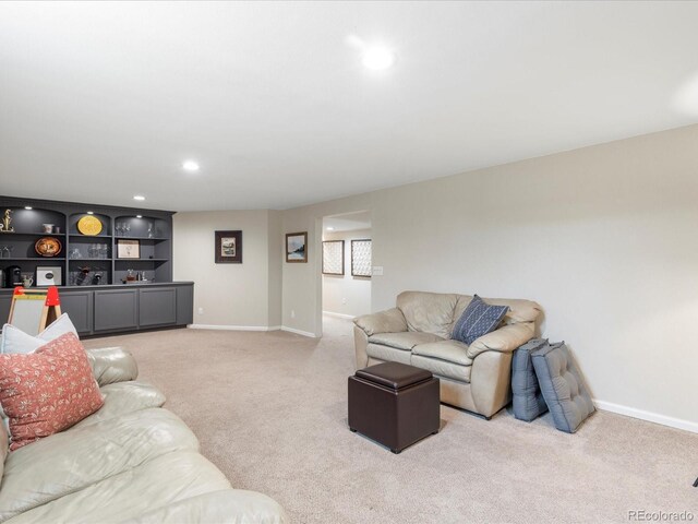 living area featuring light carpet, baseboards, and recessed lighting