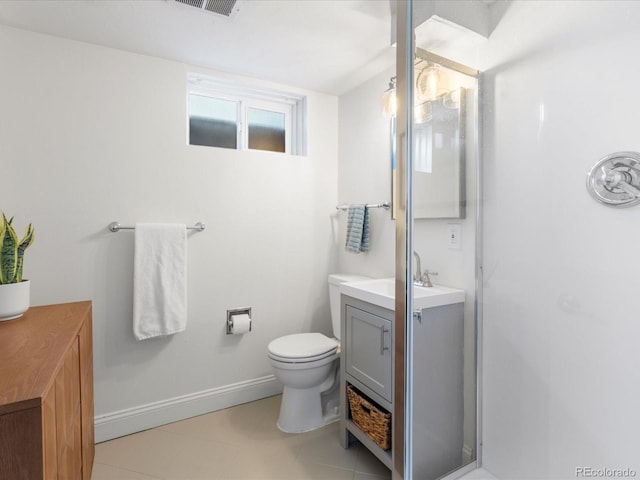 bathroom with toilet, vanity, and baseboards