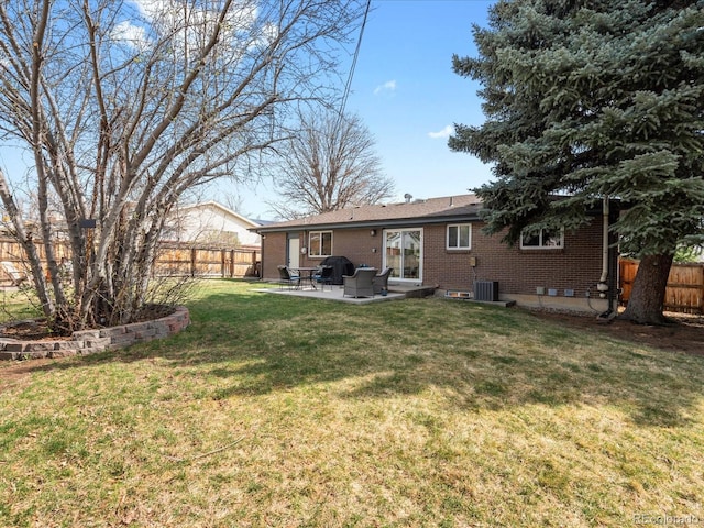 view of yard with central AC unit, fence, and a patio area