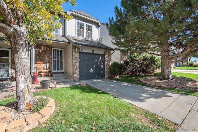 traditional home with an attached garage, stone siding, driveway, and a front lawn