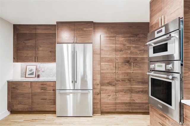 kitchen featuring stainless steel appliances and light hardwood / wood-style flooring