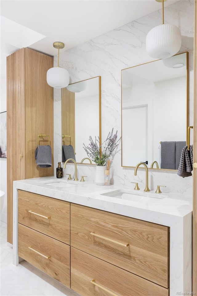 bathroom with vanity and tile walls