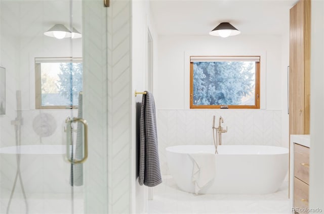 bathroom featuring vanity, tile walls, and independent shower and bath