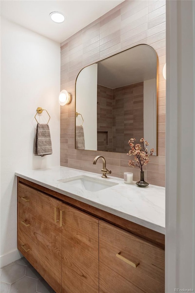 bathroom with tile patterned floors, vanity, and backsplash