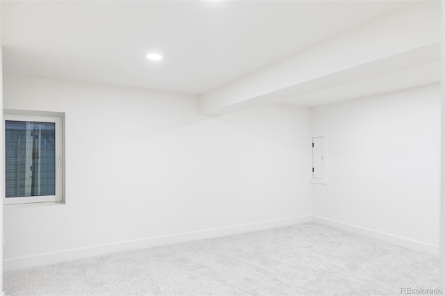 unfurnished room featuring light carpet and electric panel