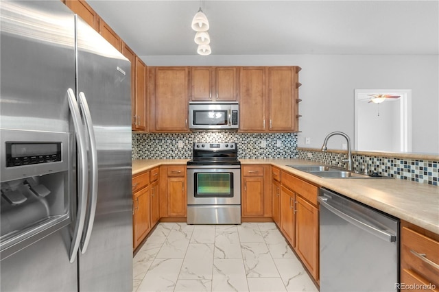 23456 E 5th Pl Unit 104, Aurora, CO 80018 - kitchen featuring stainless steel appliances, light marble finish flooring, light countertops, and brown cabinets