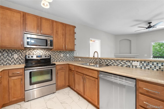 23456 E 5th Pl Unit 104, Aurora, CO 80018 - kitchen featuring stainless steel appliances, light marble finish flooring, light countertops, and open shelves