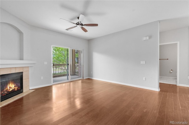 23456 E 5th Pl Unit 104, Aurora, CO 80018 - unfurnished living room with a fireplace, ceiling fan, and wood finished floors