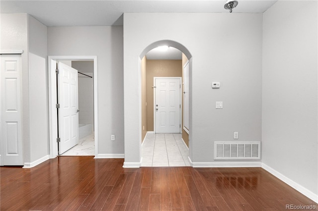 23456 E 5th Pl Unit 104, Aurora, CO 80018 - spare room featuring arched walkways and wood finished floors