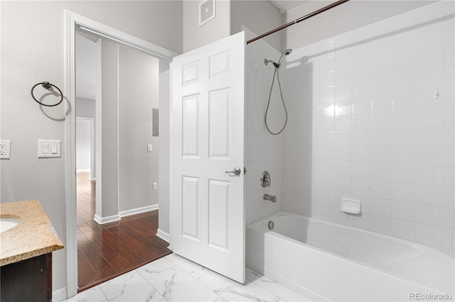 23456 E 5th Pl Unit 104, Aurora, CO 80018 - full bathroom featuring vanity, shower / tub combination, and marble look tile flooring