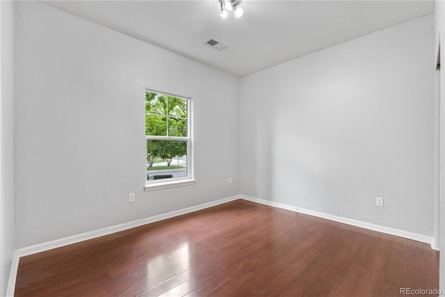 23456 E 5th Pl Unit 104, Aurora, CO 80018 - spare room with dark wood-style floors and baseboards
