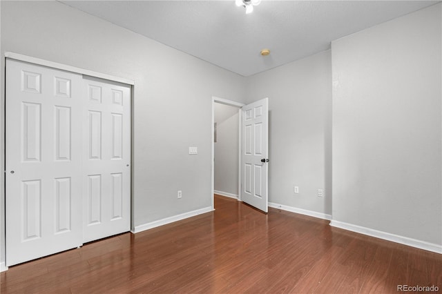 23456 E 5th Pl Unit 104, Aurora, CO 80018 - unfurnished bedroom featuring wood finished floors and a closet