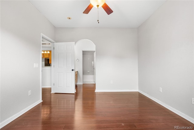 23456 E 5th Pl Unit 104, Aurora, CO 80018 - empty room featuring a ceiling fan, arched walkways, and wood finished floors