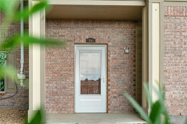 23456 E 5th Pl Unit 104, Aurora, CO 80018 - doorway to property featuring brick siding