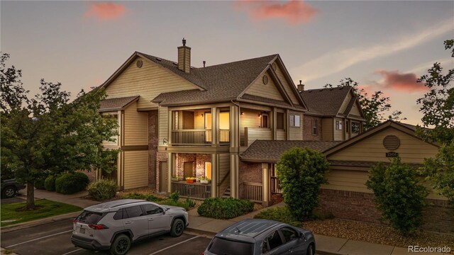 23456 E 5th Pl Unit 104, Aurora, CO 80018 - multi unit property with brick siding, uncovered parking, covered porch, a balcony, and a chimney