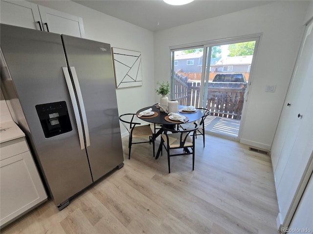 5721 W 92nd Ave Unit 66, Westminster, CO 80031 - kitchen featuring stainless steel refrigerator with ice dispenser, light wood-style flooring, white cabinetry, and baseboards