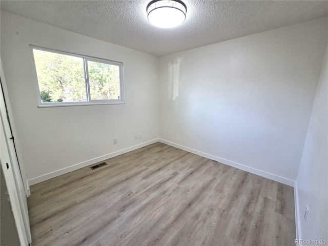 5721 W 92nd Ave Unit 66, Westminster, CO 80031 - empty room featuring a textured ceiling, light wood-style flooring, and baseboards