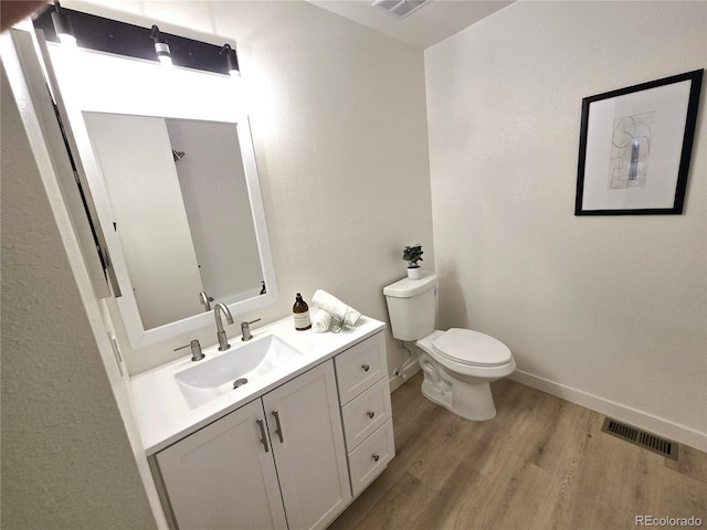 5721 W 92nd Ave Unit 66, Westminster, CO 80031 - bathroom with wood finished floors, vanity, toilet, and baseboards
