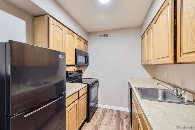 3653 S Sheridan Blvd Unit 16, Denver, CO 80235 - kitchen with black appliances, light wood-type flooring, light brown cabinets, and light countertops