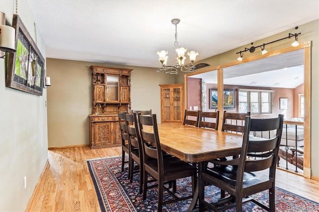 dining area featuring a chandelier and light wood-type flooring