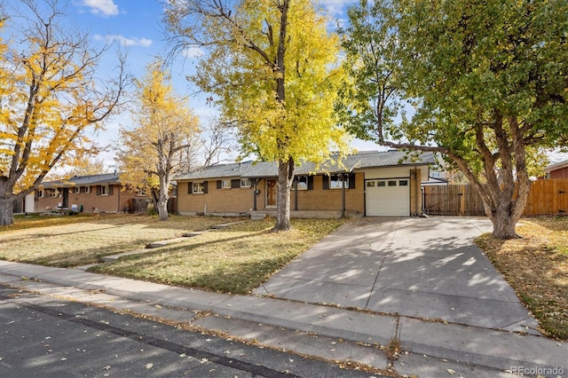 ranch-style home with a garage and a front yard