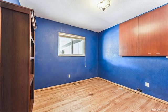 unfurnished room with light hardwood / wood-style flooring