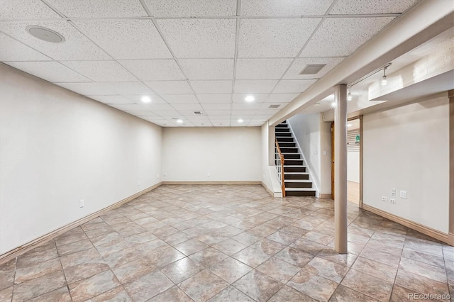 basement featuring a drop ceiling