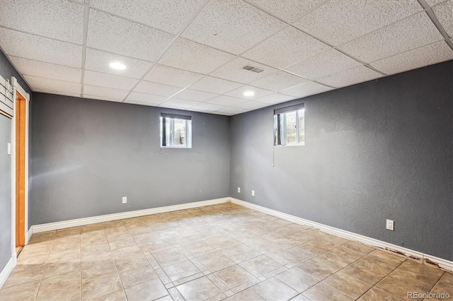 basement with a paneled ceiling