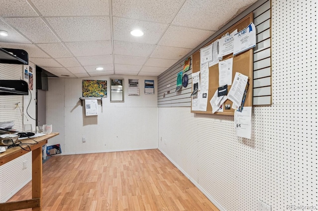 interior space with hardwood / wood-style flooring and a paneled ceiling