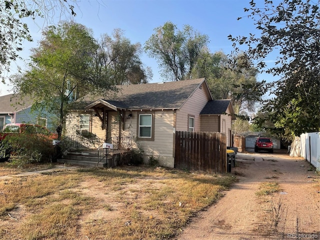 1605 7th St, Greeley, CO 80631 - view of front of property with dirt driveway and a shingled roof