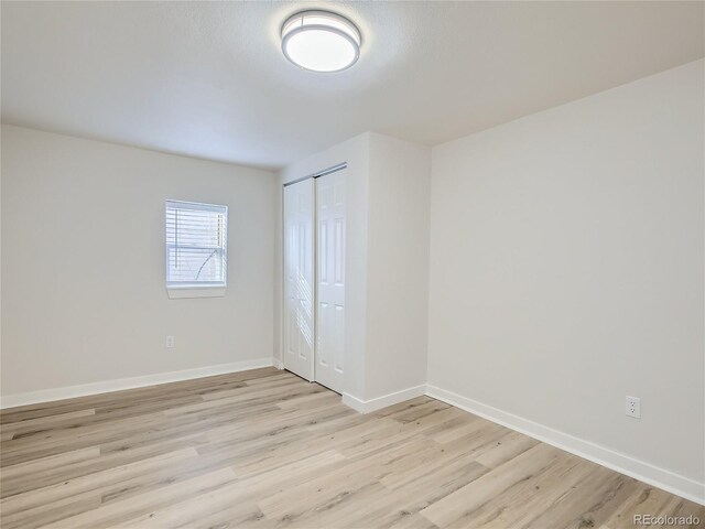 1605 7th St, Greeley, CO 80631 - unfurnished bedroom featuring light wood finished floors, baseboards, and a closet