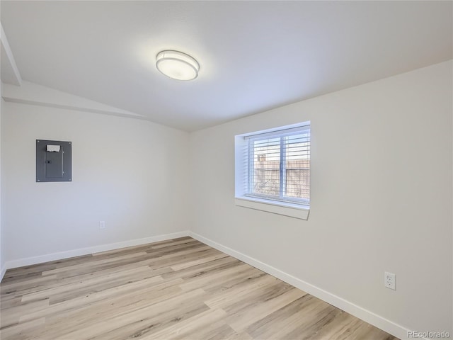 1605 7th St, Greeley, CO 80631 - spare room featuring electric panel, baseboards, and light wood finished floors
