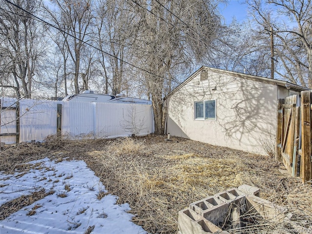 1605 7th St, Greeley, CO 80631 - view of snow covered exterior with stucco siding
