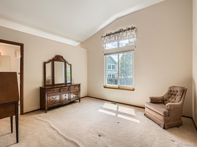 living area featuring carpet floors, vaulted ceiling, and baseboards