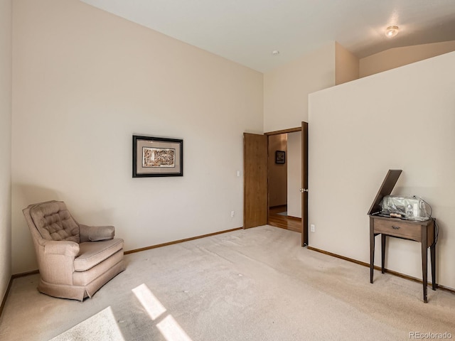 unfurnished room with carpet floors, baseboards, and vaulted ceiling