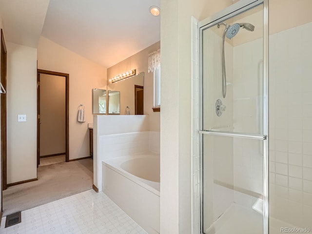full bathroom featuring a shower stall, lofted ceiling, a garden tub, baseboards, and tile patterned floors