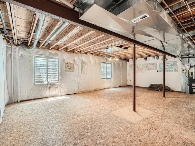 below grade area featuring plenty of natural light and heating unit