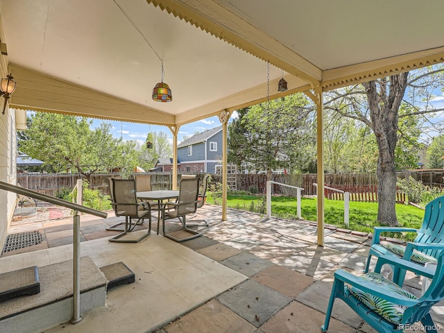view of patio with outdoor dining area and a fenced backyard
